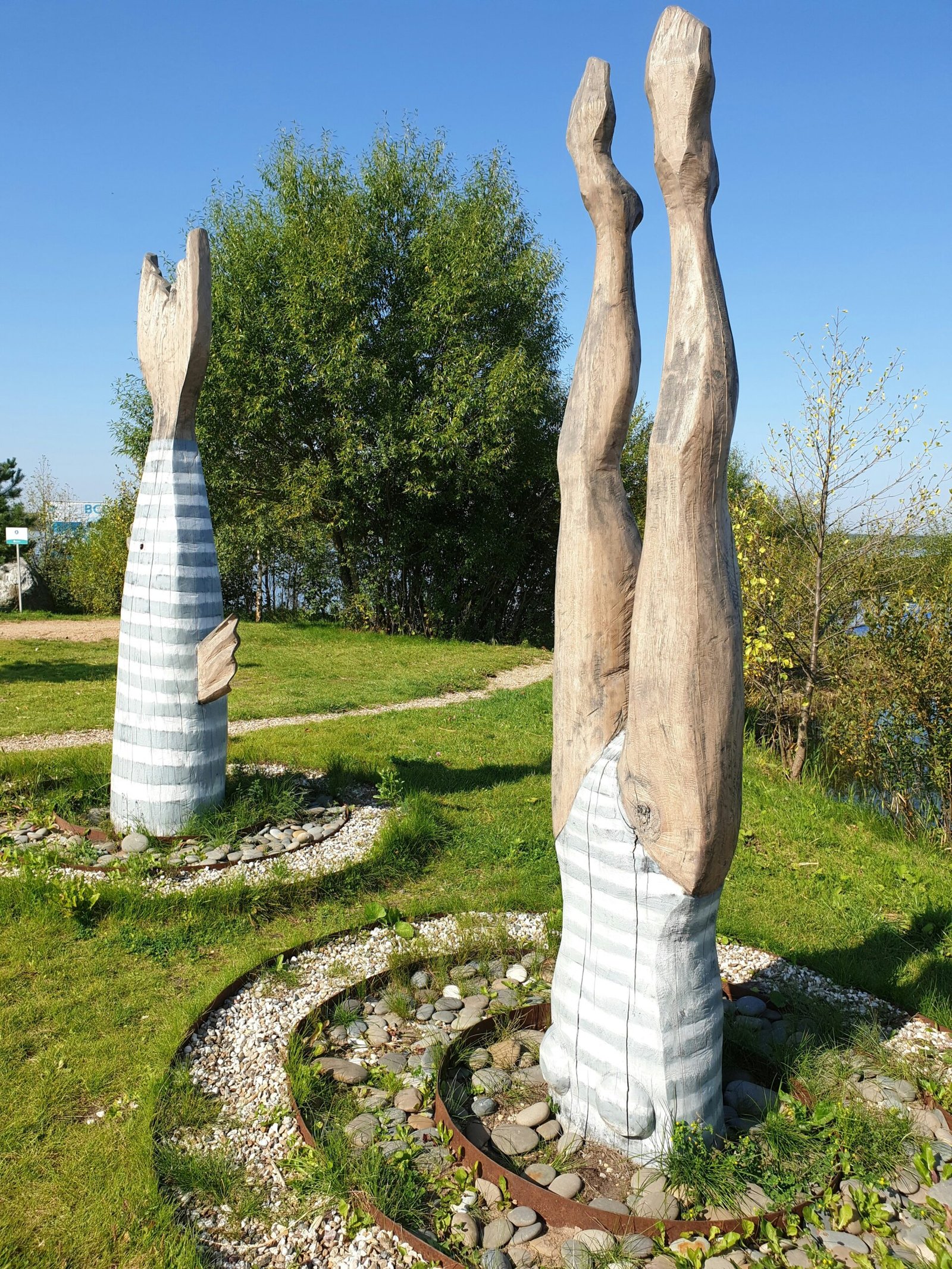 a couple of large sculptures sitting on top of a lush green field